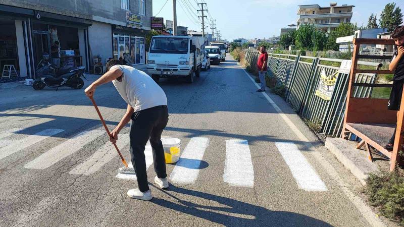 ÇOCUKLARININ GÜVENLİĞİNDEN ENDİŞE EDEN HASAN GÜÇLÜ, ÖĞRENCİLERİN YOLUN KARŞISINA GEÇTİĞİ NOKTAYA KENDİ İMKANLARIYLA YAYA GEÇİDİ ÇİZDİ.