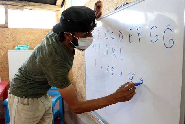 SAVAŞTAN KAÇTI, ÇADIRDA OKUMA YAZMA ÖĞRETİYOR